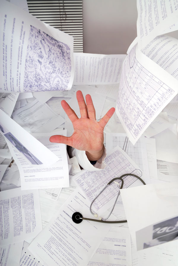Doctor's hand reaching up from overwhelming medical paperwork — Dict8ion AI transcription eliminates admin burden for specialists